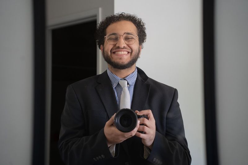 Andy Shalaby holding his camera