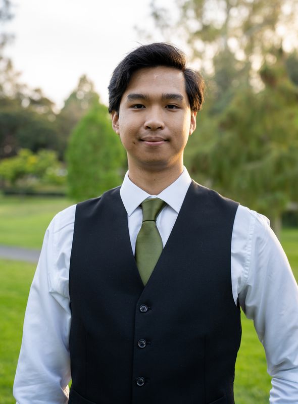 A portrait of a young man in a vest and tie