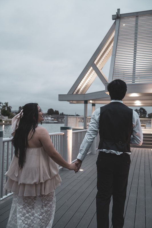 She glances back over her shoulder while they walk