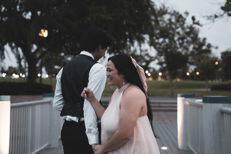 Close in, mid-laugh, on the boardwalk
