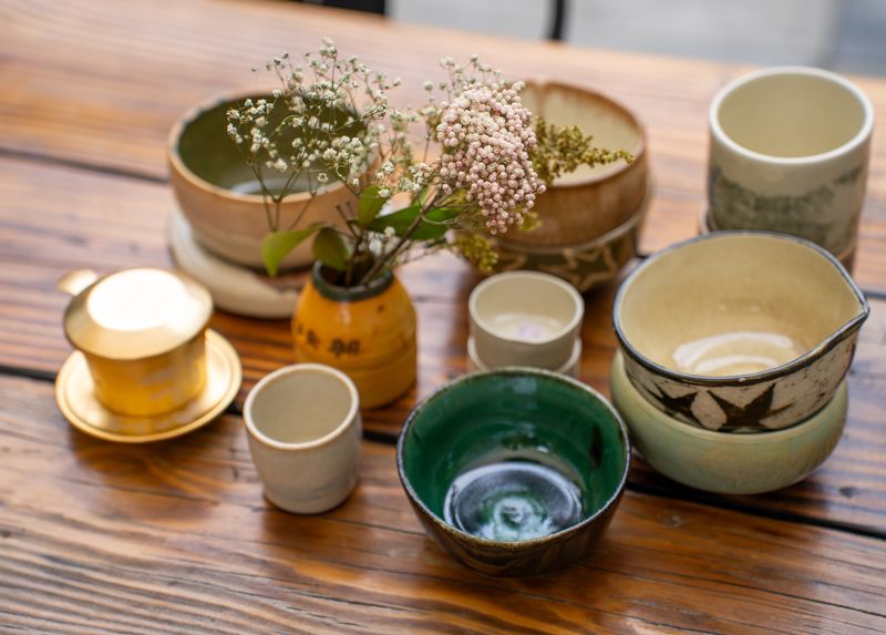 Handmade ceramics arranged on a wooden table