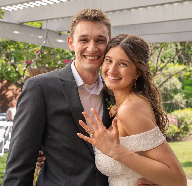 The bride and groom smiling together